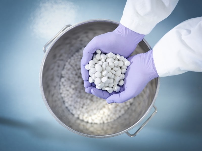 gloved-hands-holding-pills