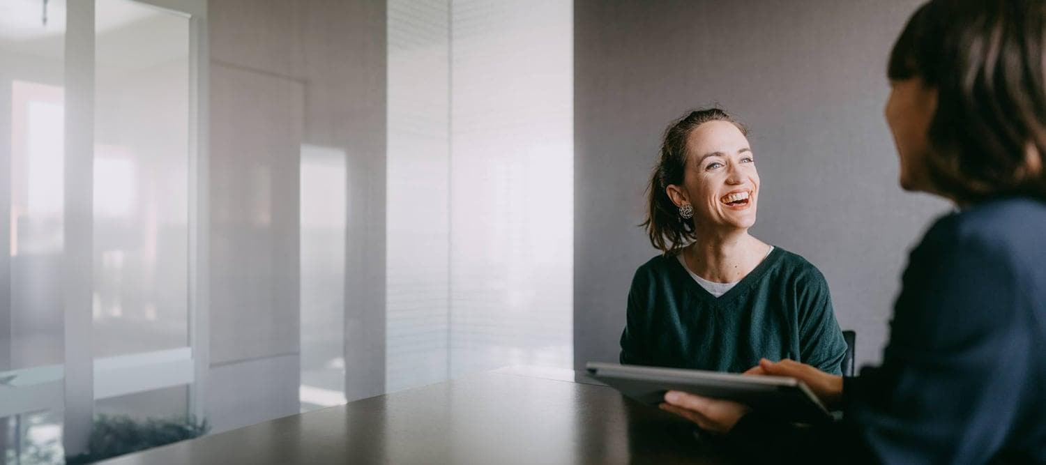 AI in Insurance Cheerful woman smiling during consultation