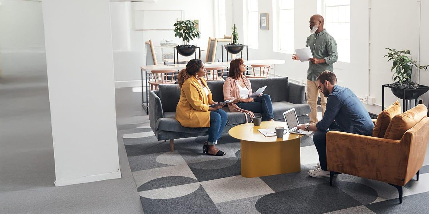 Diverse group of coworkers casually meeting in open office